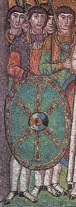 Legerofficieren met een schild waarop het Christusmonogram (San Vitale te Ravenna, 6de eeuw).